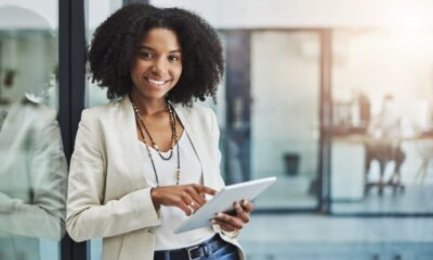 Make it your business to be tech savvy and industrious. Portrait of a young businesswoman smiling and holding a digital tablet in her office.
