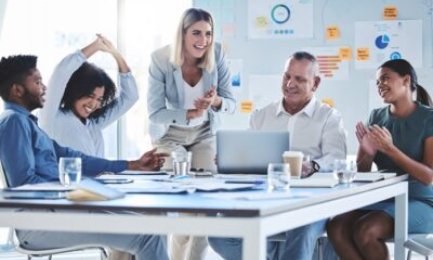 Business people in celebration for success in marketing meeting, happy about team collaboration and motivation for advertising strategy on laptop. Support, planning and creative ideas in work office.